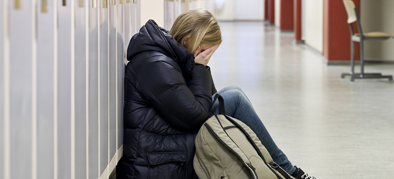 Image of a young person crying at school